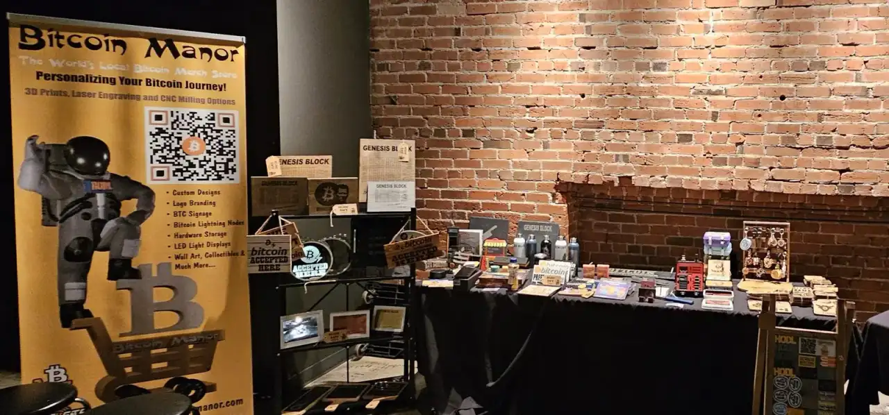 Bitcoin Manor's merch table at a Calgary bitcoin event